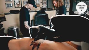 tattoo-artist-holding-his-licence-permit